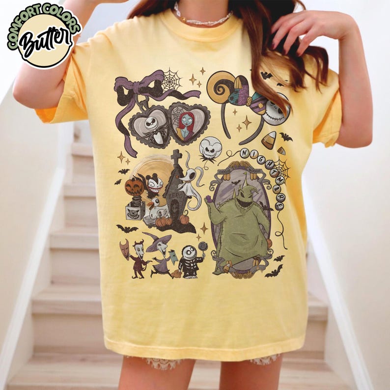 May include: Yellow t-shirt featuring a variety of cartoon characters and elements from "The Nightmare Before Christmas." The design includes Jack Skellington, Sally, Oogie Boogie, and other characters. The shirt has a crew neck and short sleeves.