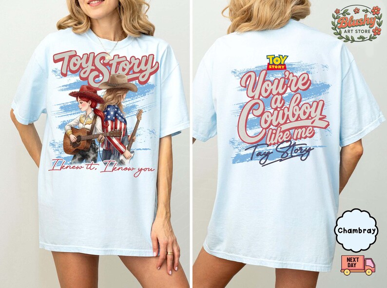 May include: A light blue t-shirt featuring a front graphic of two figures with guitars and the text Toy Story and I knew it, I know you. The back graphic displays the Toy Story logo, the text You're a Cowboy like me, and Tay Story.