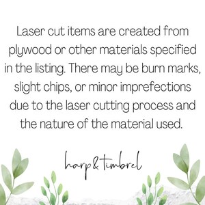 May include: Text on a white background with green foliage on the sides. The text reads: "Laser cut items are created from plywood or other materials specified in the listing. There may be burn marks, slight chips, or minor imperfections due to the laser cutting process and the nature of the material used. harp & timbrel"