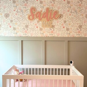 pink and white wooden nursery name sign with custom name