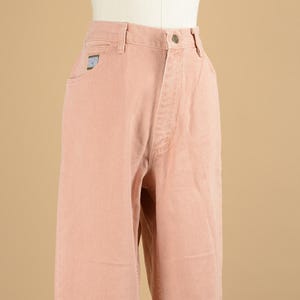 May include: A pair of light pink, high-waisted, straight-leg jeans.
