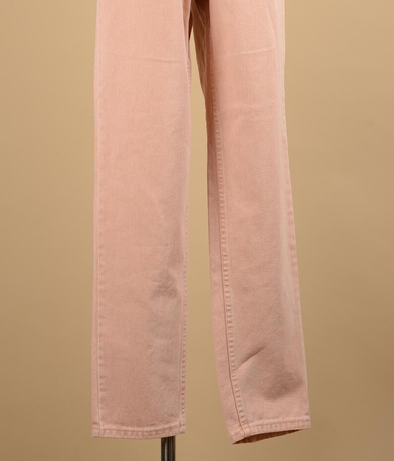 May include: A pair of light pink pants with a straight leg fit.
