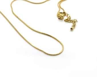 May include: A gold snake chain necklace with a lobster clasp closure.