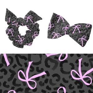 May include: A scrunchie and a bow, both in a dark grey leopard print with light pink bows. The scrunchie is round and gathered, while the bow is a classic shape. A matching fabric swatch is at the bottom.