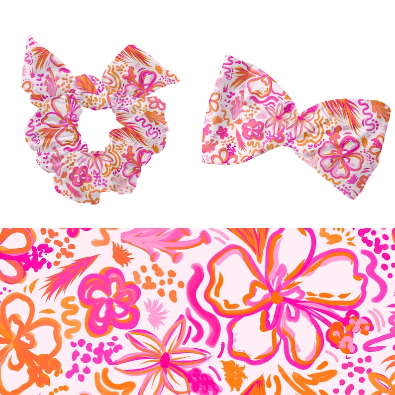 May include: A pink and orange floral print hair scrunchie and bow tie set. The print features abstract shapes, flowers, and swirls.