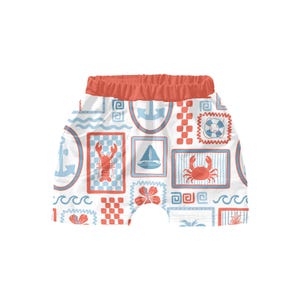 May include: White and red patterned shorts with a nautical theme. The pattern includes anchors, sailboats, crabs, lobsters, and life preservers.