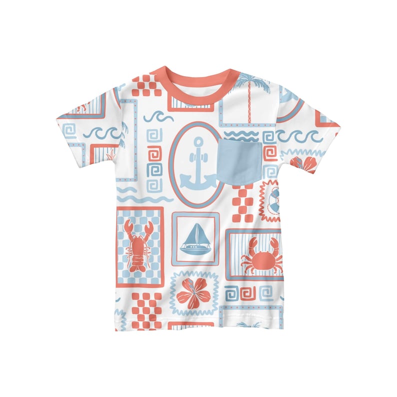 May include: White short-sleeved t-shirt with a blue and red nautical themed pattern. The pattern includes anchors, sailboats, crabs, and lobsters. The shirt has a blue pocket on the left side.