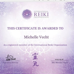 May include: A certificate from the International Reiki Organization. The certificate is purple and white with the text "THIS CERTIFICATE IS AWARDED TO Michelle Vecht". It is signed by the Executive Director and dated 2019-09-16.