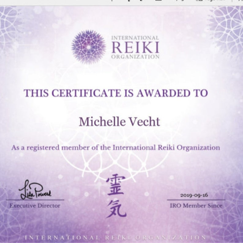 May include: A certificate from the International Reiki Organization. The certificate is purple and white with the text "THIS CERTIFICATE IS AWARDED TO Michelle Vecht". It is signed by the Executive Director and dated 2019-09-16.