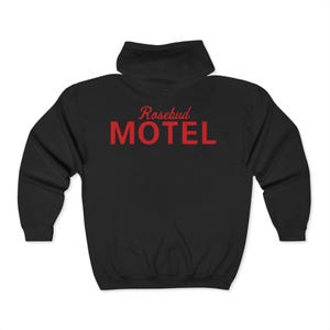 May include: Black hooded sweatshirt with the text "Rosebud Motel" in red on the back.
