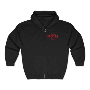May include: Black zip-up hoodie with a red embroidered design that says "Roadside Motel" and "Steve".
