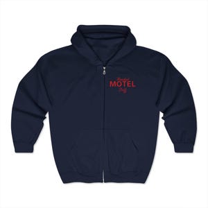 May include: A navy blue zip-up hoodie with the text "Roadside Motel Staff" in red.
