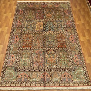 May include: An intricately designed area rug with a repeating pattern of trees and floral motifs in shades of red, green, and beige. The rug has a detailed border and a rectangular shape.