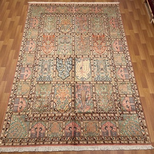 May include: An ornate, rectangular rug with a detailed, repeating pattern in shades of beige, pink, green, and orange. The design features floral and geometric motifs, creating a traditional aesthetic. The rug is displayed on a wooden floor.