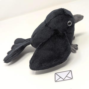 Plush crow bird with one wing with pocket plush animal gift