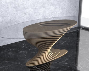May include: A modern, oval-shaped glass-top coffee table with a unique, swirling wooden base. The base is made of multiple layers of wood, creating a dynamic and eye-catching design.