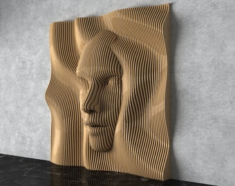May include: A wooden wall sculpture of a face with a wavy, abstract design. The sculpture is made of thin, layered strips of wood that create a 3D effect.