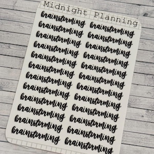 May include: A sheet of clear stickers with the word "brainstorming" written in black cursive lettering. The sheet has the words "Midnight Planning" and "SS251" printed on it.