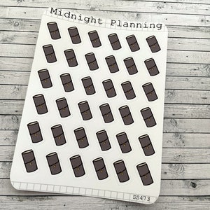 May include: A sheet of stickers featuring 36 brown and gold notebook icons. The sheet is labeled "Midnight Planning" and "SS473".