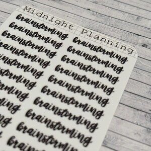 Pu&ograve; includere: Un foglio di adesivi con le parole "Midnight Planning" in alto. Il foglio &egrave; pieno della parola "brainstorming" ripetuta pi&ugrave; volte in un font scritto a mano.