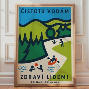 May include: A framed poster featuring a stylized graphic illustration of a landscape with green hills, dark green trees, and a river. The design includes stick figures swimming, playing with a ball, and kayaking. Text reads: ČISTOTU VODÁM ZDRAVÍ LIDEM! Solo Lipník · ČSN 49 4705.