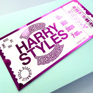 May include: A pink metallic concert ticket for Harry Styles, featuring the text "Together Harry Styles". The ticket is for December 12th, 2026, at 7:00 PM. It includes a barcode and the words "General Admission". The ticket is on a light blue background.