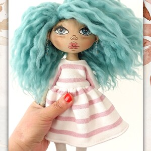May include: A handmade doll with blue curly hair, wearing a pink and white striped dress and white socks. The doll has painted blue eyes, a pink nose, and red lips.
