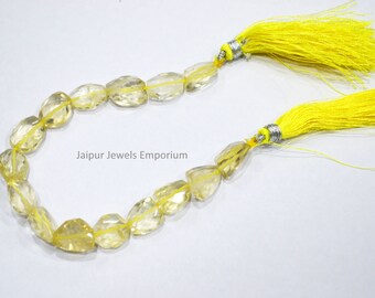 May include: A strand of yellow citrine gemstone beads with faceted edges. The beads are strung on a cord with yellow tassels at each end. The strand is approximately 18 inches long. Jaipur Jewels Emporium is printed on a white background.