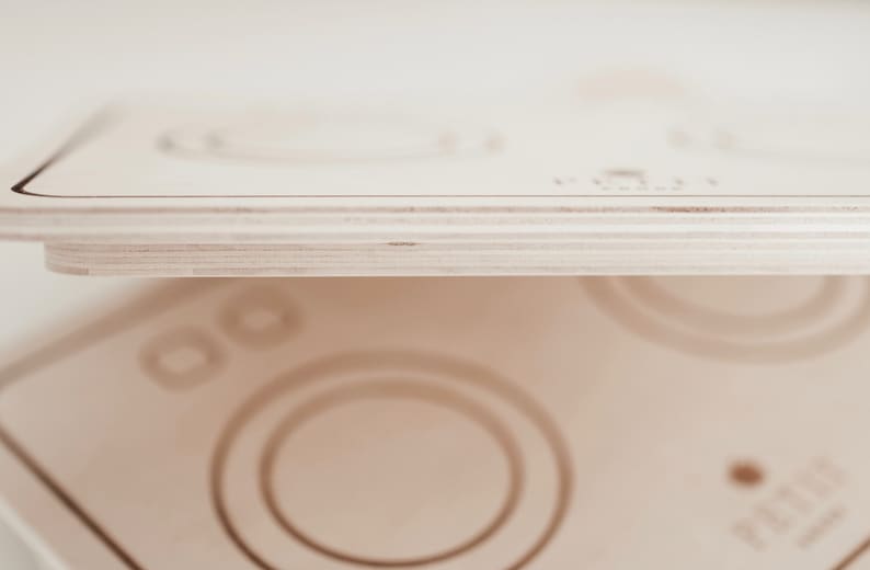 Puede incluir: Un juego de madera con forma de lavadora con un acabado pintado de blanco. El juego tiene un dial redondo con el texto "PLAYTIME" impreso en &eacute;l.