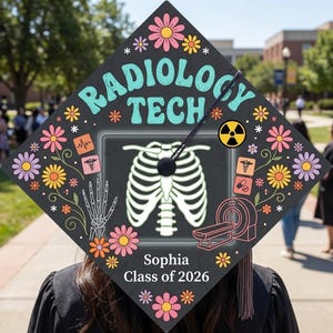 May include: A black graduation cap decorated with the words "Radiology Tech" in teal, surrounded by colorful flowers and medical-themed graphics. The cap features an X-ray image of a rib cage and the name "Sophia, Class of 2026".