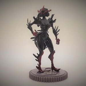 Può includere: Una statuetta dettagliata in nero e rosso di una creatura con un design organico e spinoso. La statuetta è in piedi su una base viola con un design a ingranaggio.