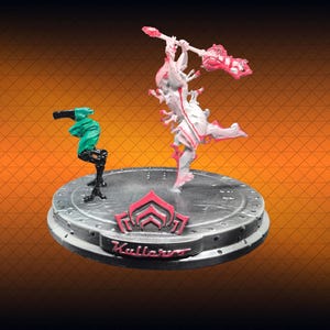 May include: A detailed figurine set featuring two characters on a circular base. One figure is white and pink, holding a weapon. The other is teal. The base has the word "Kullervo" in red.
