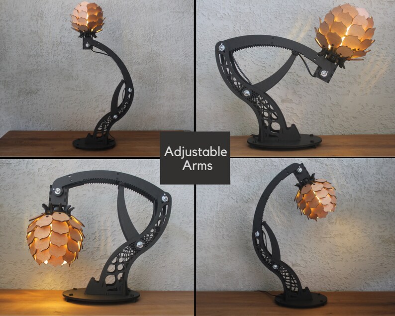 May include: A black metal table lamp with adjustable arms and a unique, geometric design. The lampshade is made of wood and has a light brown finish. The lamp is lit and casting a warm glow.