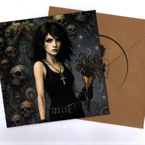 May include: An illustrated card featuring a woman in a black outfit holding flowers, with a background of skulls and stars. The card is next to a brown envelope.