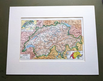 May include: A vintage map of Switzerland, showing the country's topography and major cities. The map is printed in a variety of colors, including green, brown, and blue. The title "SUISSE" is printed in the lower left corner of the map.