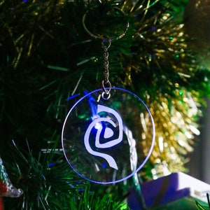 Roswell inspired crystal clear keychain with a frosted Antar symbol on. image 3