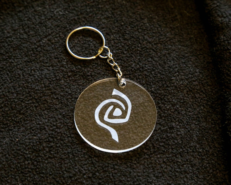 Roswell inspired crystal clear keychain with a frosted Antar symbol on. image 2