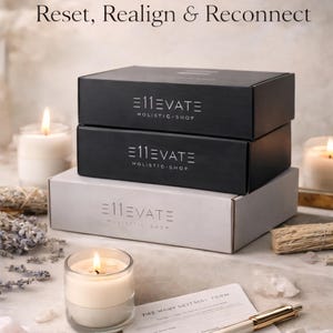 May include: Three boxes, two black and one white, with the text "E11EVATE HOLISTIC SHOP". A lit candle, crystals, a pen, and a form are in the foreground. The text "Your Moment to Reset, Realign & Reconnect" is at the top.