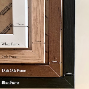 May include: A set of four rectangular picture frames in white, oak, dark oak, and black finishes. Each frame features a 29mm wide border. The frames are nested together, displaying their distinct colors and wood grain textures clearly.