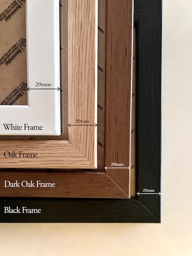May include: A set of four rectangular picture frames in white, oak, dark oak, and black finishes. Each frame features a 29mm wide border. The frames are nested together, displaying their distinct colors and wood grain textures clearly.