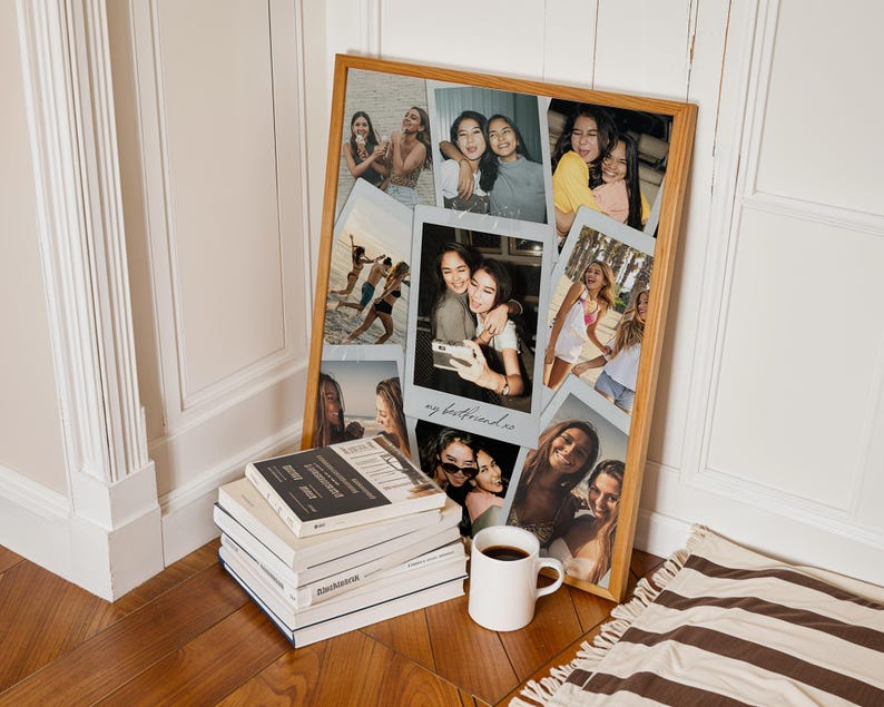 May include: A rectangular wooden frame containing a collage of multiple candid photographs of friends. The central photo features the handwritten text "my bestfriend xo" in cursive script. The frame is positioned next to a stack of books and a white mug.