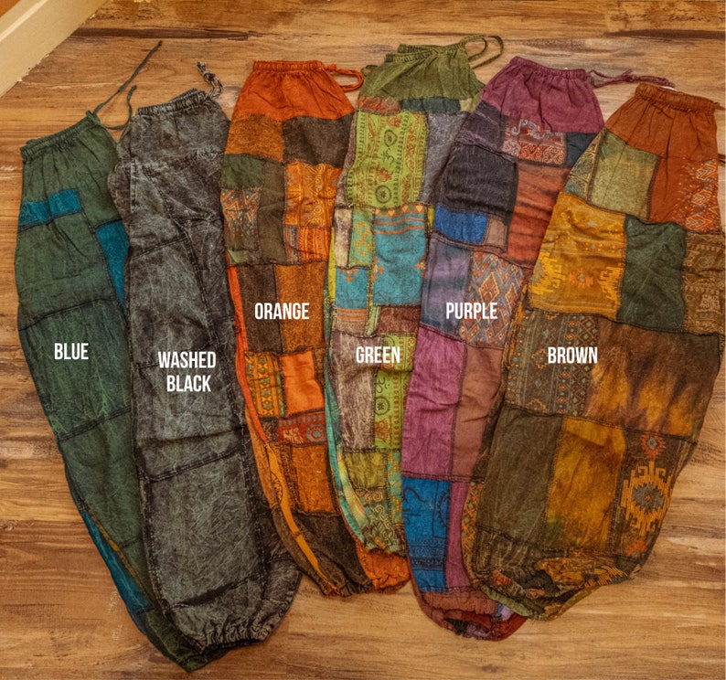 May include: Six pairs of patchwork pants in different colors, including blue, washed black, orange, green, purple, and brown. The pants are made of a variety of fabrics and have a unique, bohemian style.