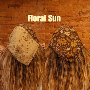 May include: Two women with long brown hair are wearing brown and tan floral print bandanas. The bandanas are tied around their heads and have a variety of floral and geometric patterns. The text "Floral Sun" is written in white letters on a brick wall background.