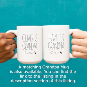 Op de afbeelding: Twee witte koffiemokken met zwarte tekst. De mok aan de linkerkant zegt "Oliver's Grandpa est. 2022" met een voetafdruk symbool. De mok aan de rechterkant zegt "Hazel's Grandma est. 2022" met een voetafdruk symbool.
