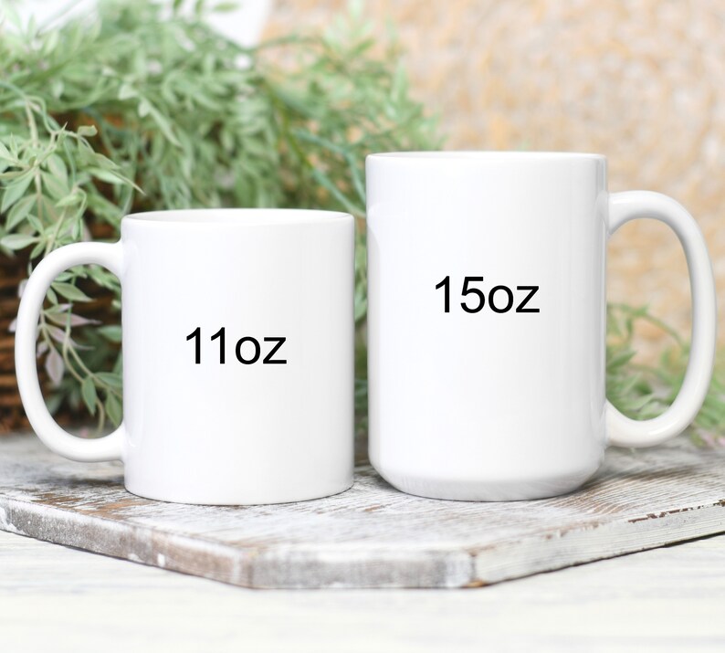 May include: Two white ceramic mugs with black text. The mug on the left is 11 oz and the mug on the right is 15 oz.