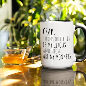 May include: White coffee mug with a black handle. The mug has black text that reads "CRAP. TURNS OUT THIS IS MY CIRCUS AND THOSE ARE MY MONKEYS".