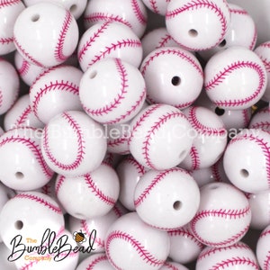 May include: A collection of white baseball-themed beads with red stitching. Each bead has a hole for stringing. The BumbleBead Company logo is visible in the lower left corner.
