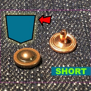 May include: Close-up of two copper-coloured jean rivets. One rivet is a cap, the other has a post. A teal-coloured pocket outline is in the upper left corner, with an arrow pointing to the rivets. The word "SHORT" is in a green box.