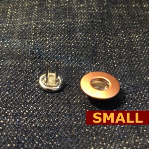 May include: Two metal snaps, one silver and one copper, for attaching fabric. The copper snap is labeled "SMALL".