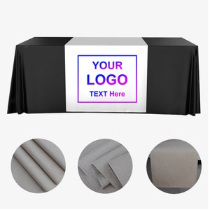 May include: A black table cover with a white center runner. The runner has a blue and purple outlined box with the words "YOUR LOGO TEXT Here". Three detail shots of the fabric are shown below.